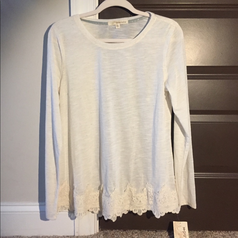 Cream colored long sleeve top